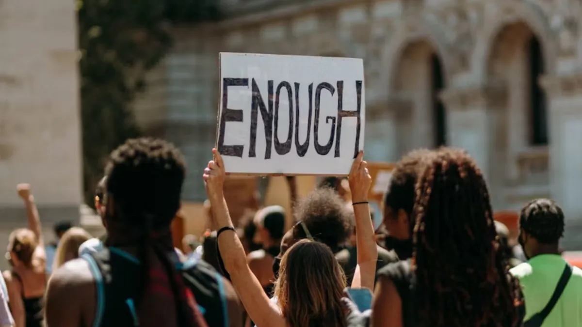 People holding an “Enough” sign.