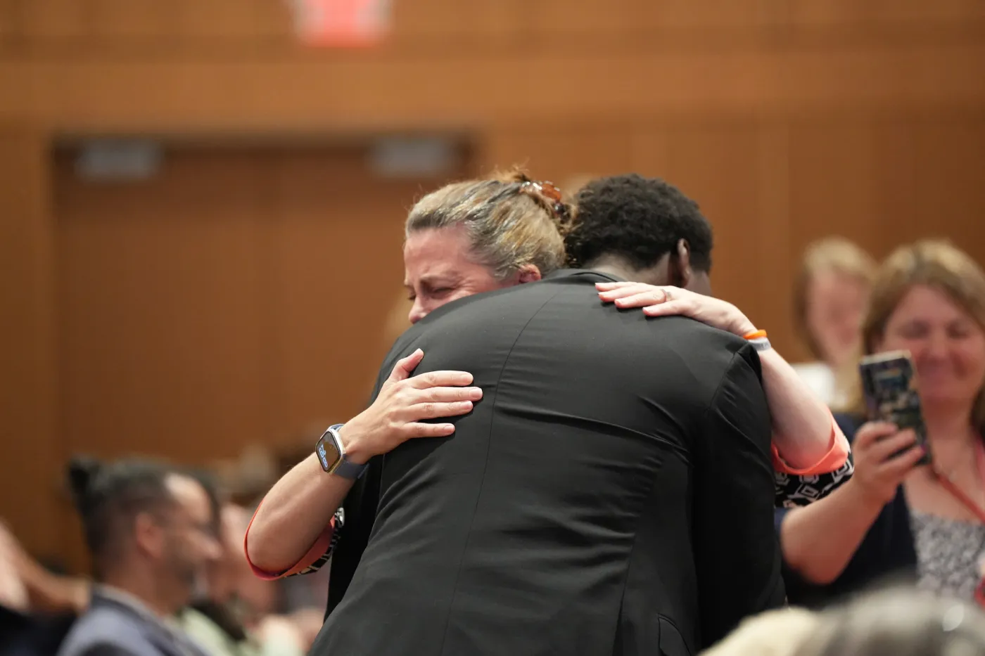 Bendeshe Bonner, 2026 Human and Civil Rights recipient, hugs his mom after accepting the award.