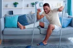 man with crutches and broken leg