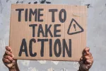 Sign reading “Time to Take Action.”