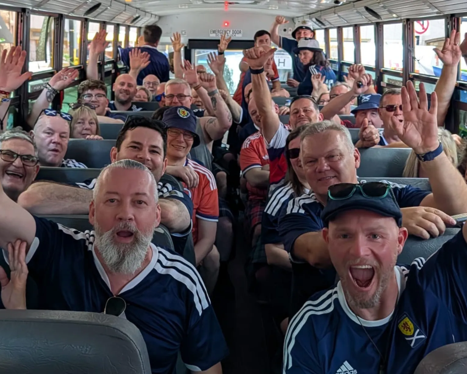 Scots, members of the 'Tartan Army' cheering inside one of the many yellow school buses they took to Foxborough to watch World Cup games.