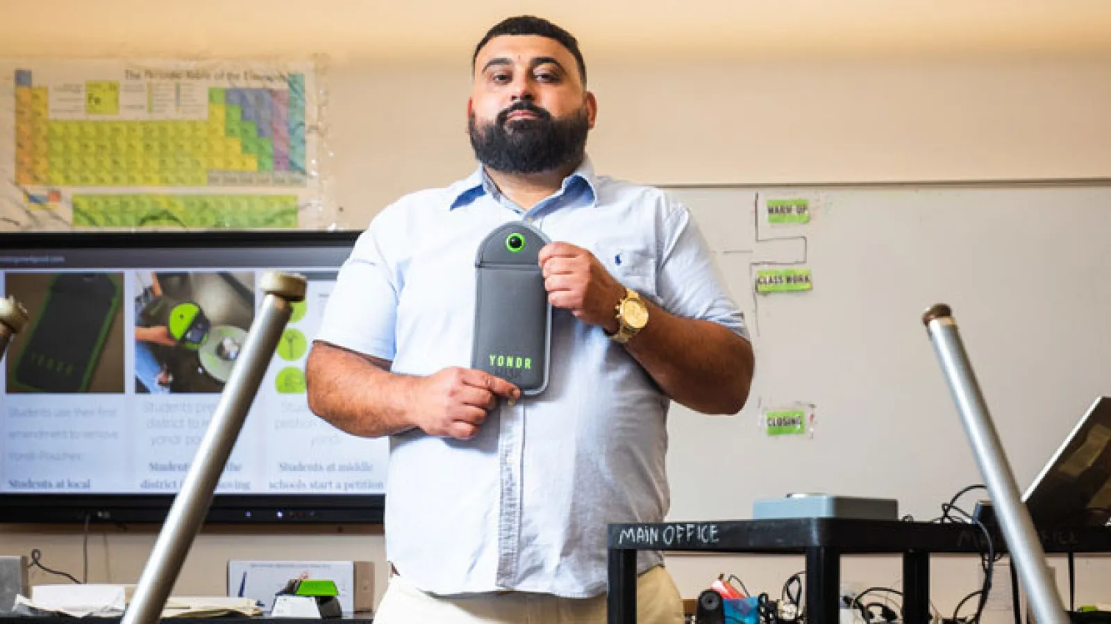  Joseph Michael, who teaches science in Fall River, shows the Yondr pouch used in that district. 