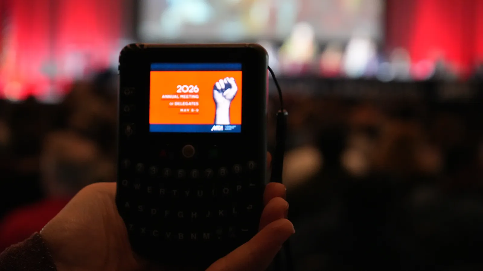 MTA Annual Meeting of Delegates was held on May 8 & 9, 2026 at the Hynes Convention Center. The photo is of a a hand holding the voting device used by Annual Meeting delegates conducting the union's business.