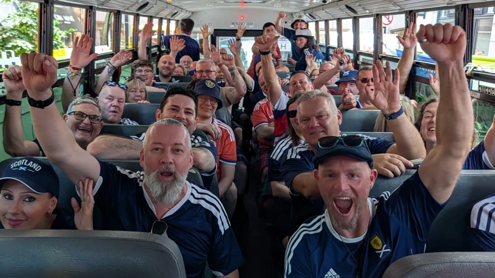 Scots, members of the 'Tartan Army' cheering inside one of the many yellow school buses they took to Foxborough to watch World Cup games.