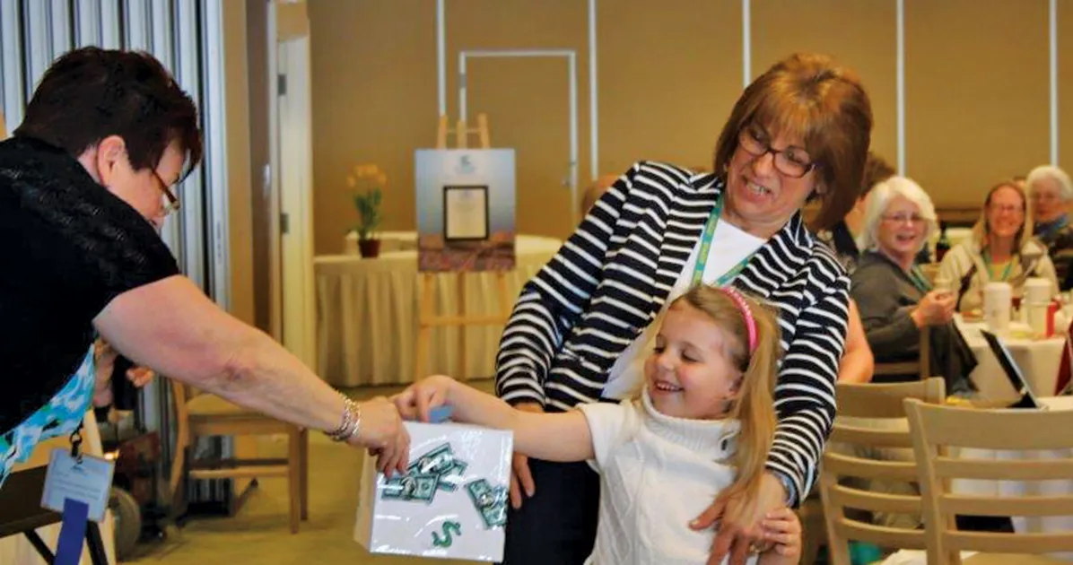 image of diane barnum helping a child