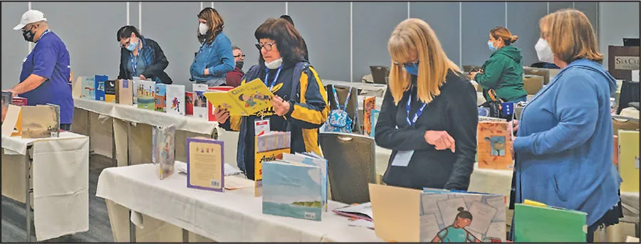 ESPs attending a workshop called "All Kinds of Diversity: Books and Materials for PreK-6 Classrooms" perused samples of works that could be added to classrooms or libraries.