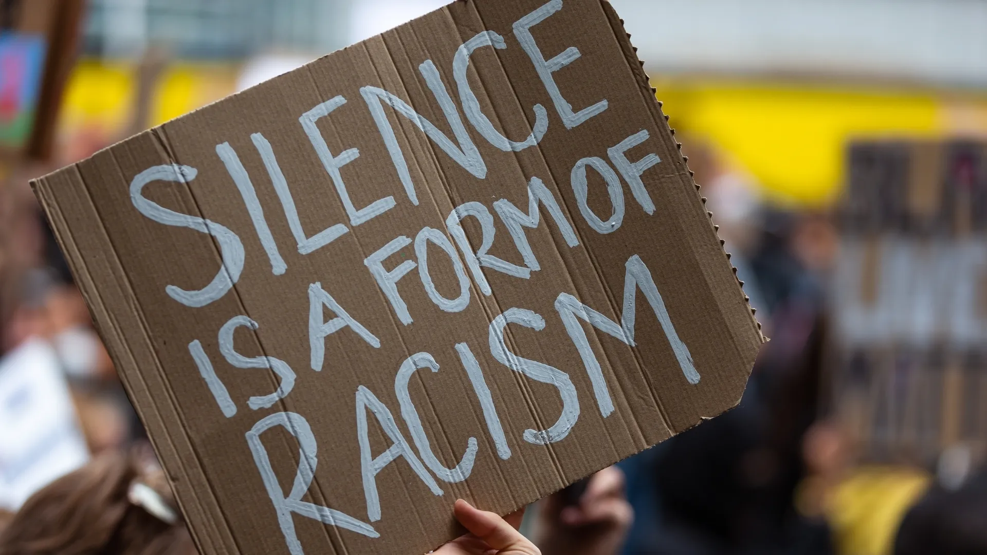 Photo of a sign that says “Silence is a form of racism.”