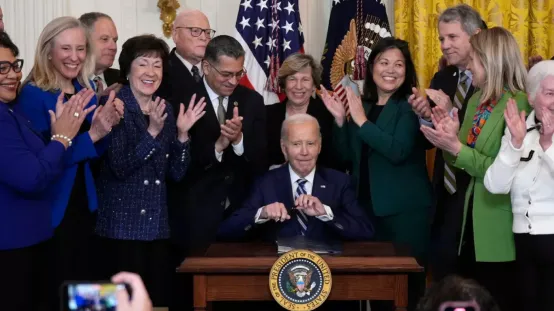 Joe Biden with a group of collaborators on the day he signed the Social Security Fairness Act.