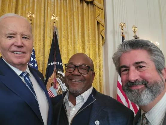 President Joe Biden with an unidentified man and MTA President Max Page in January 2025 at the signing of GPO-WEP repeal legislation.
