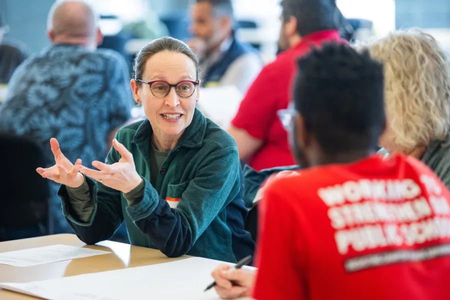 Group of members in conversation following a successful ballot question.